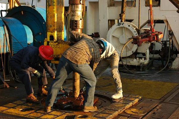 Rig crew making connection during drilling operations.